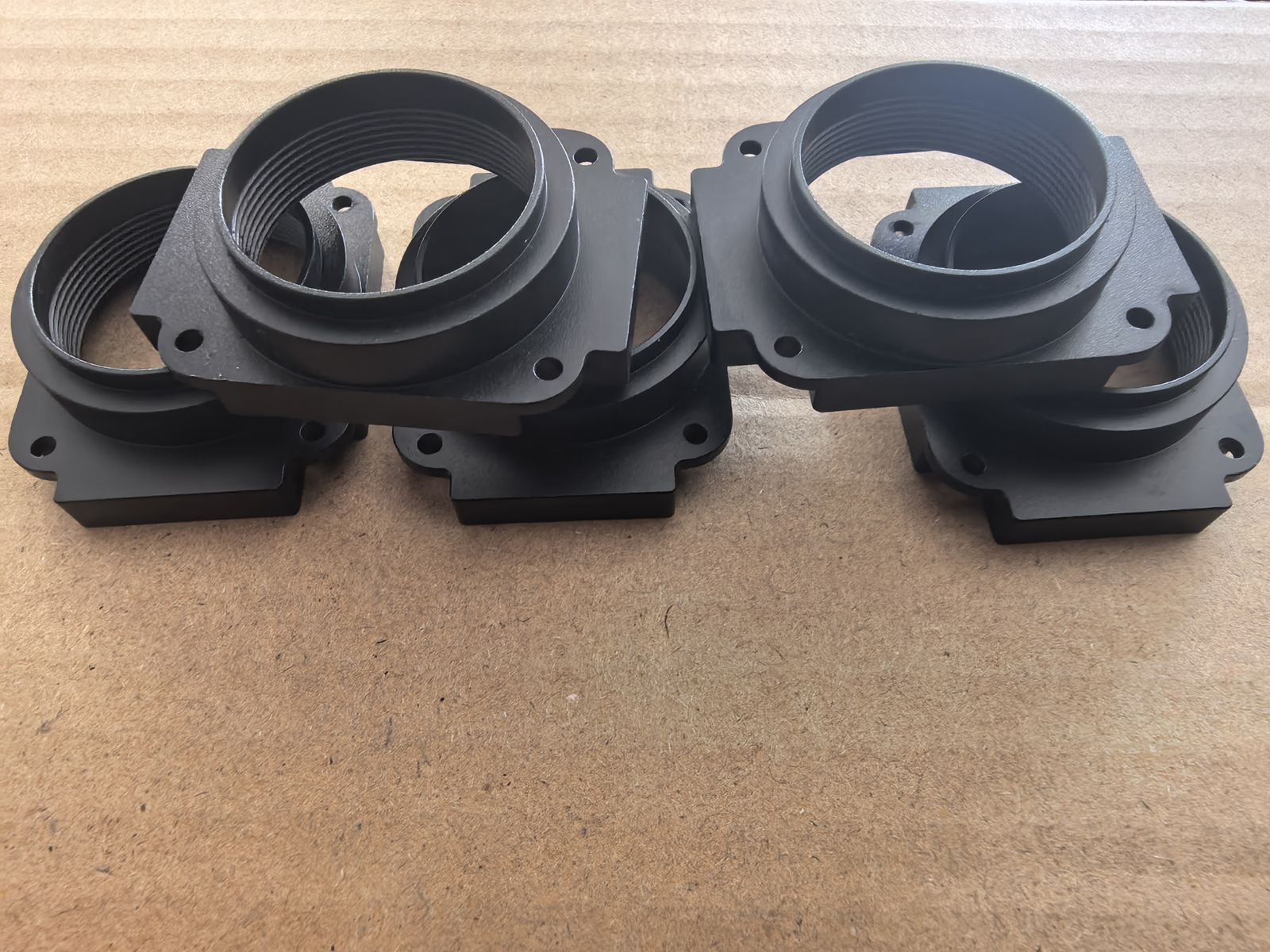 Four black anodized aluminum sensor housings